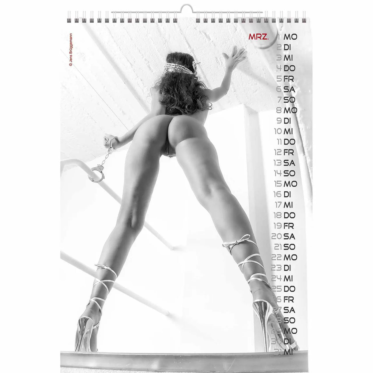 Calendar page with a black and white image of a woman in lingerie and high heels, holding a glass.