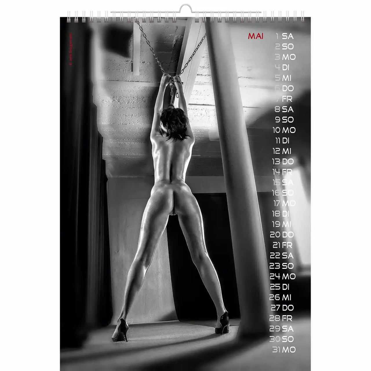 Calendar with a black and white image of a person hanging from chains, with dates on the right side.
