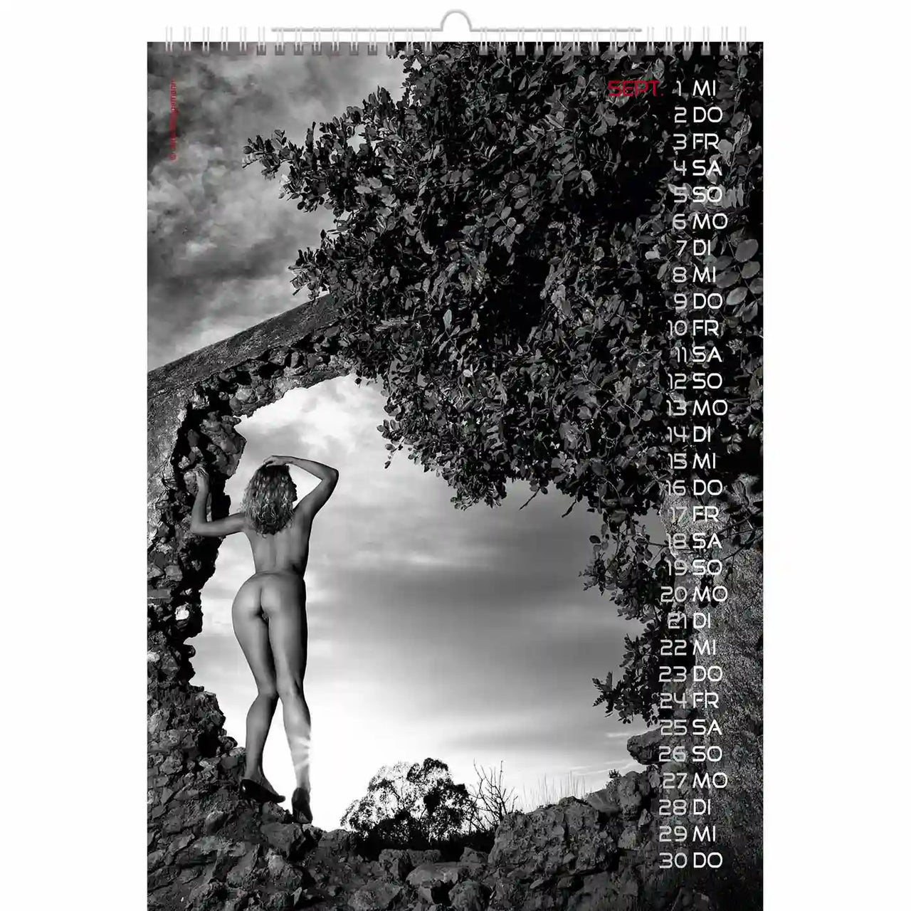 Calendar with a black and white photo of a person on rocks and trees, with dates listed vertically.