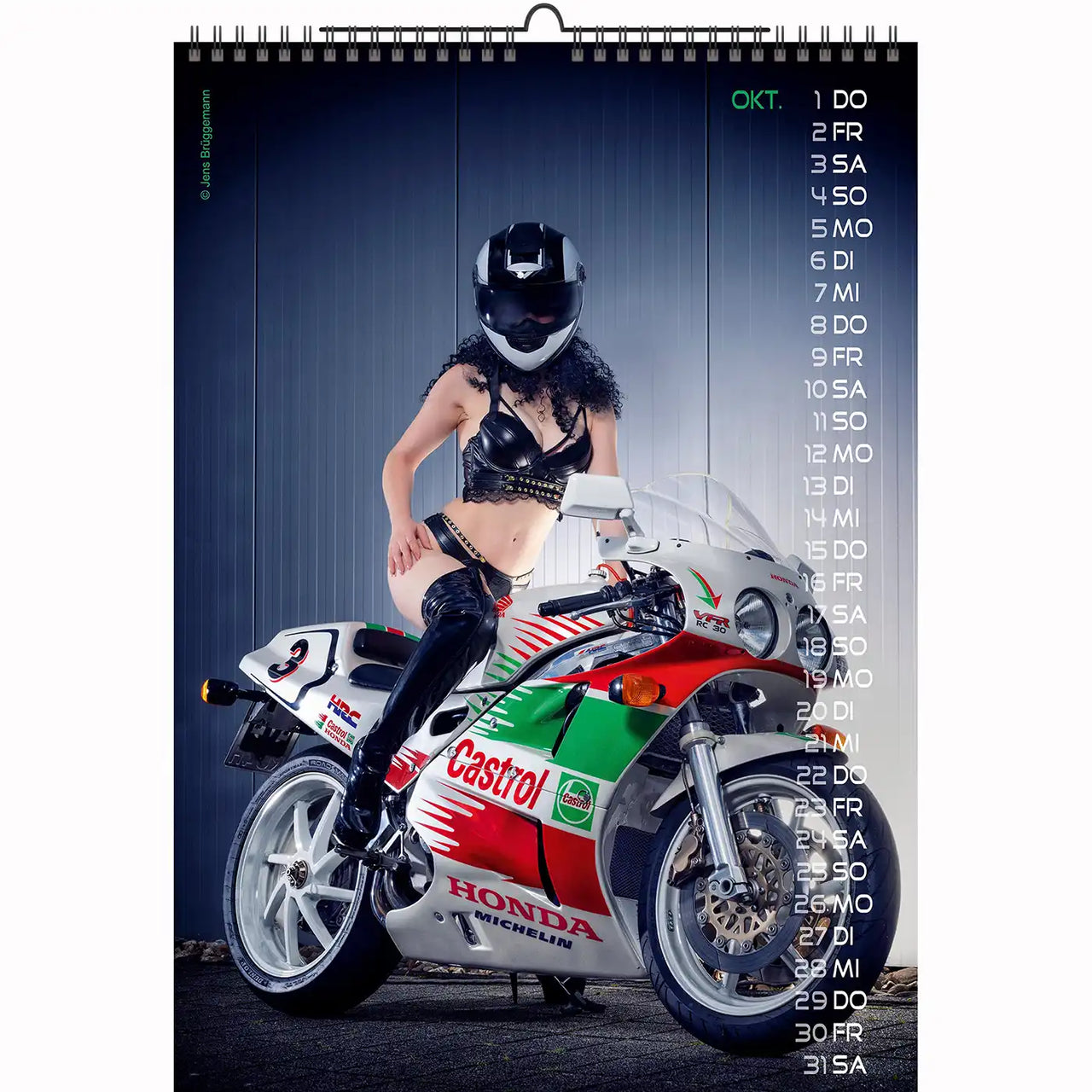 Wall calendar photo featuring woman in leather outfit posing on sport bike with helmet
