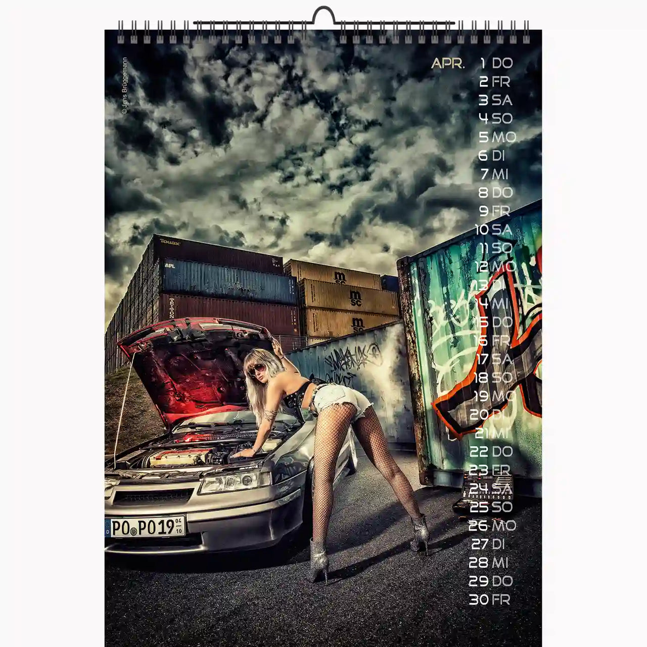 Calendar with a woman inspecting a car in an urban setting