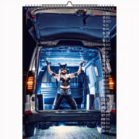 Calendar with a person in a costume standing in the open trunk of a car, with vehicle interior visible.