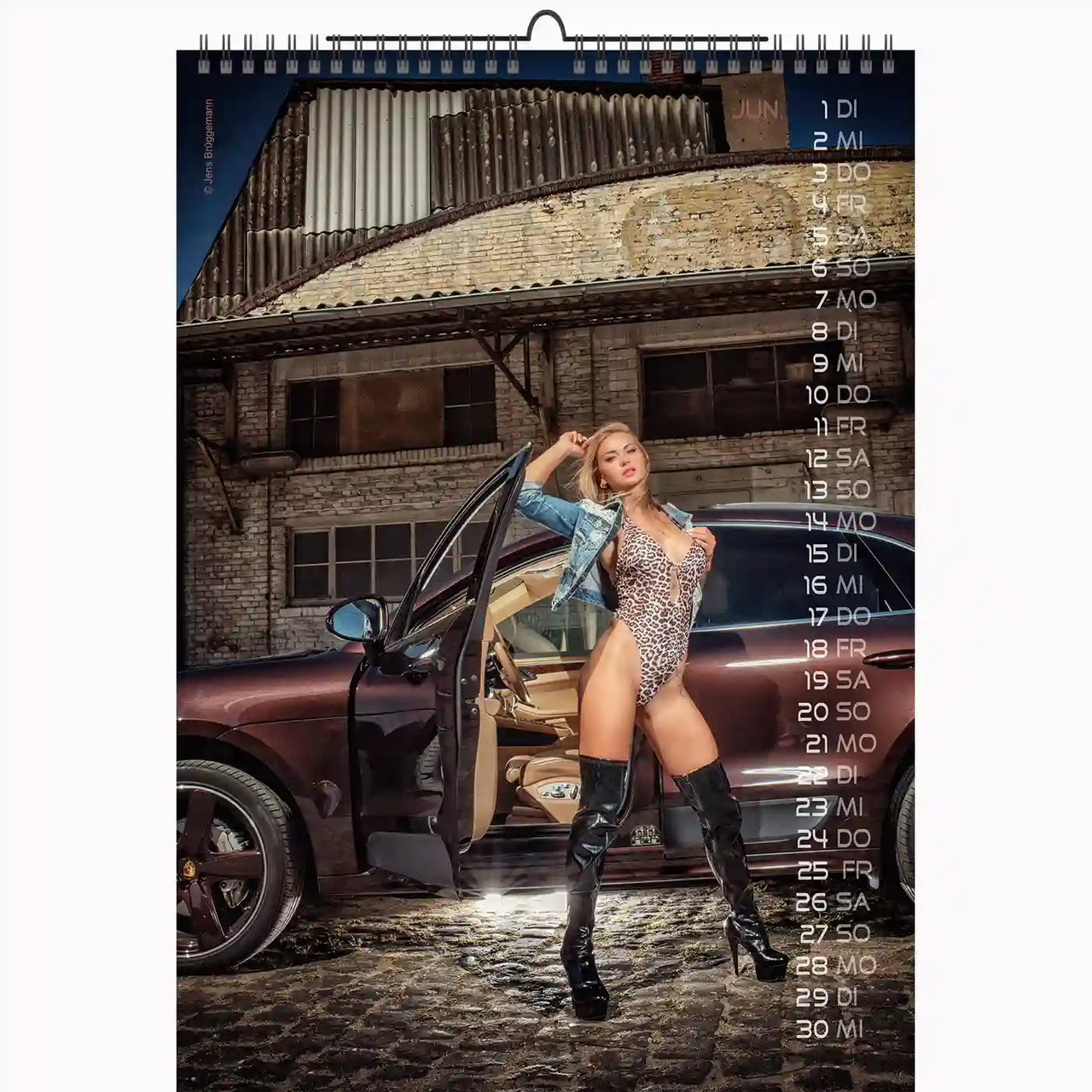 Calendar with a model in a leopard print outfit standing next to a car, set against a brick building.