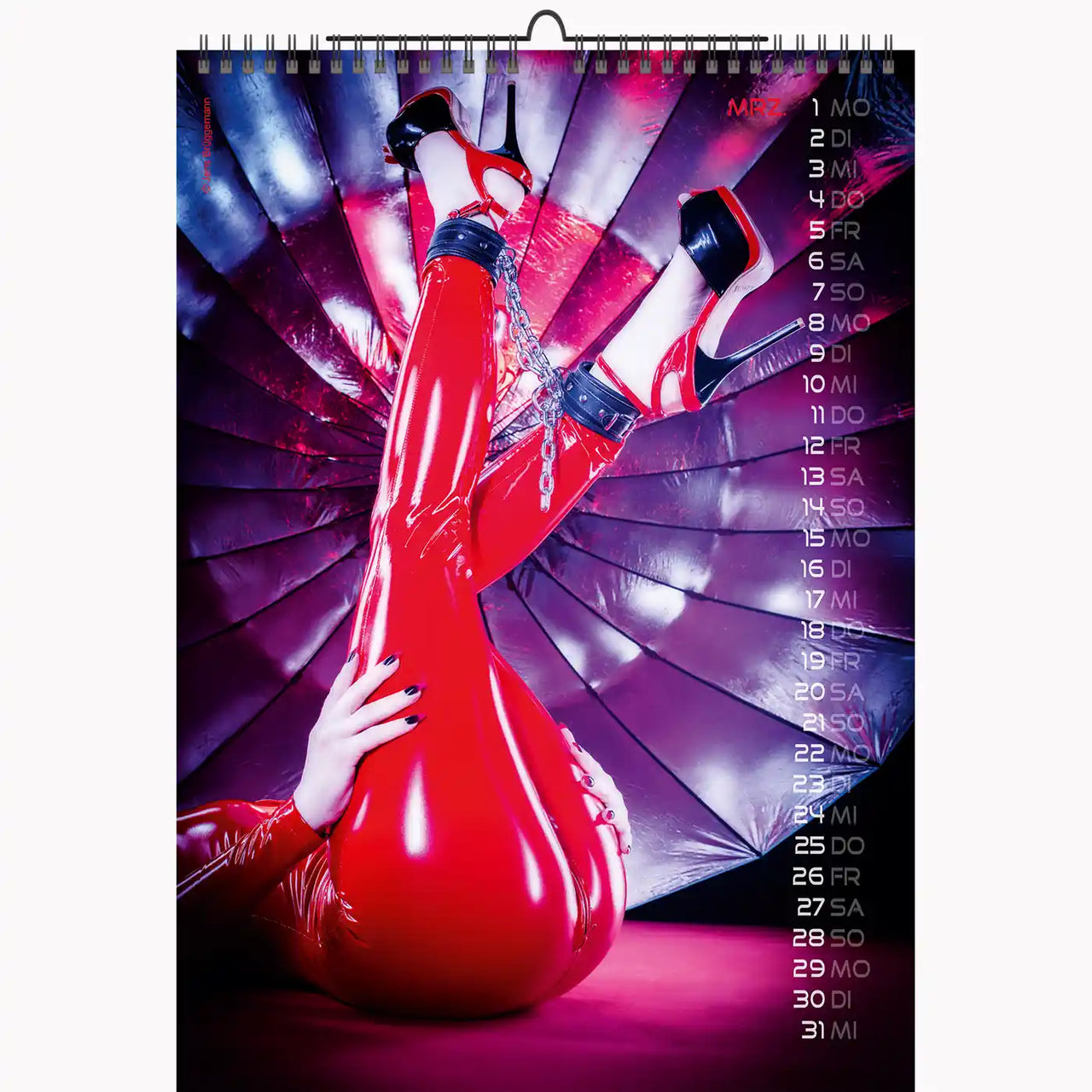 Calendar with a stylized design of a person in red shoes and pants against a purple and pink abstract background.