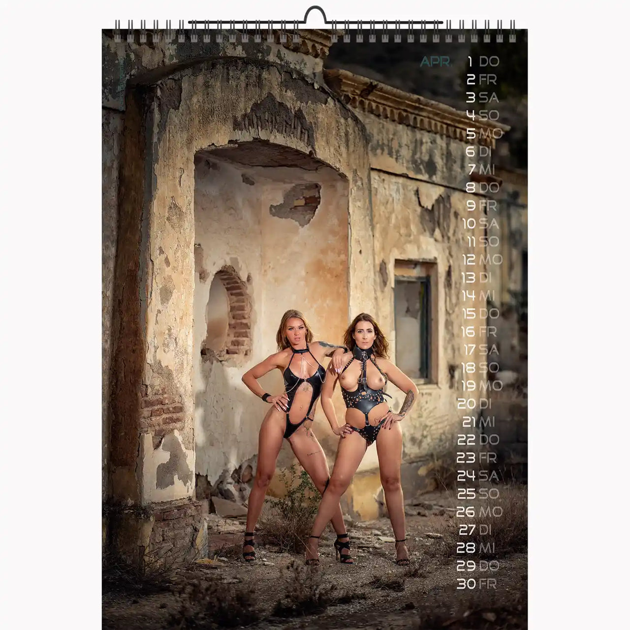 Calendar with two women in black lingerie standing in an old, ruined building.