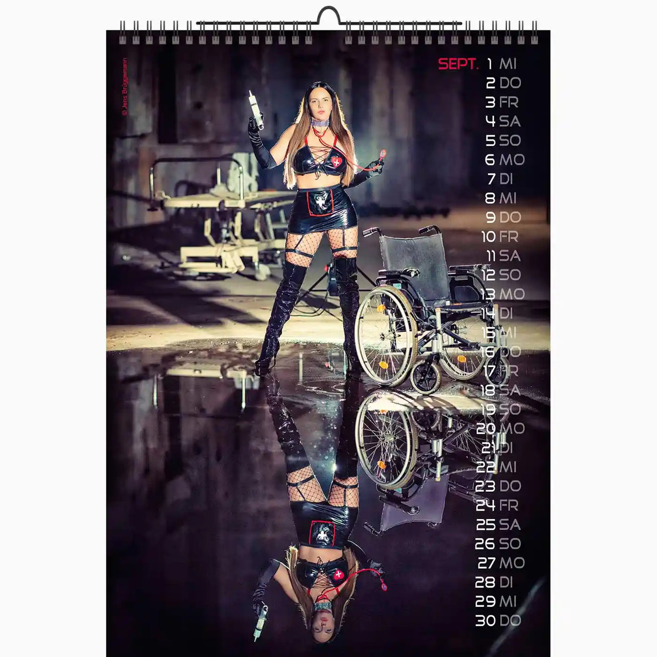 Calendar with a woman in a wheelchair and leather outfit on a reflective surface.