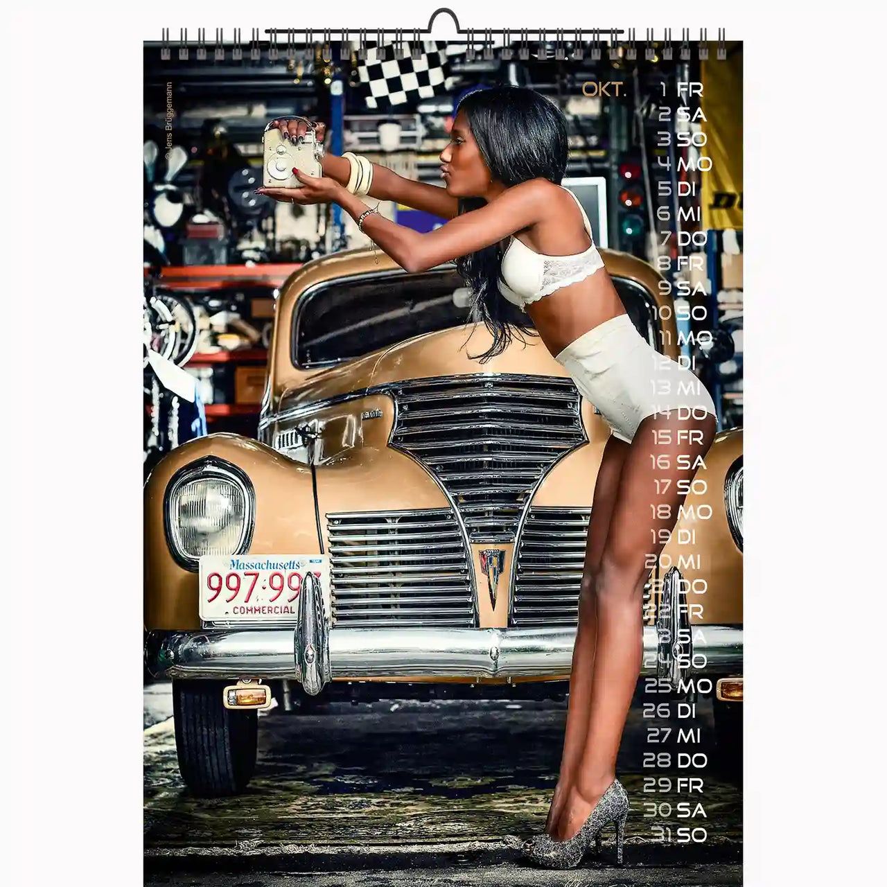 Calendar with a woman leaning on an old car in a garage setting