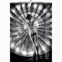 Calendar with a black and white photo of a person against a metallic spiral background