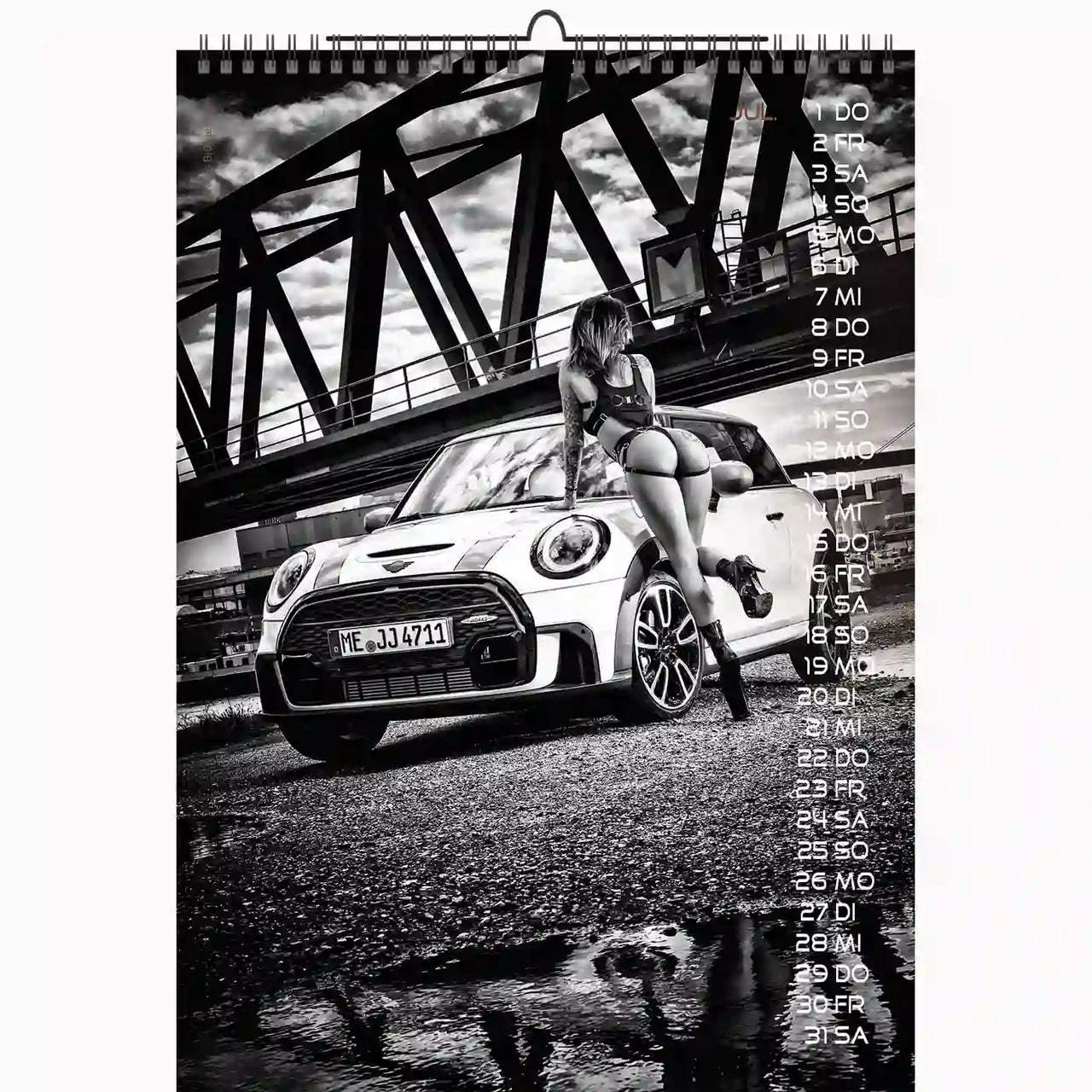 Calendar with a black and white photo of a car and a person sitting on it, with a bridge in the background.