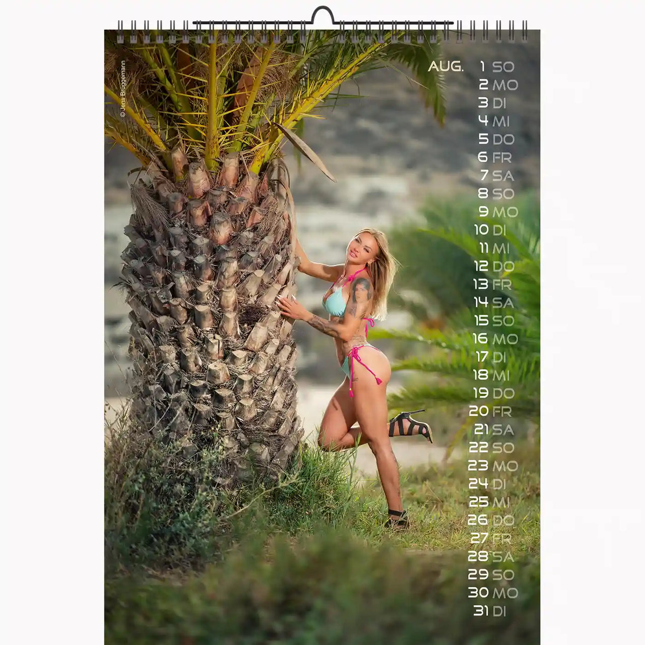 Calendar page with a woman in a bikini leaning against a palm tree
