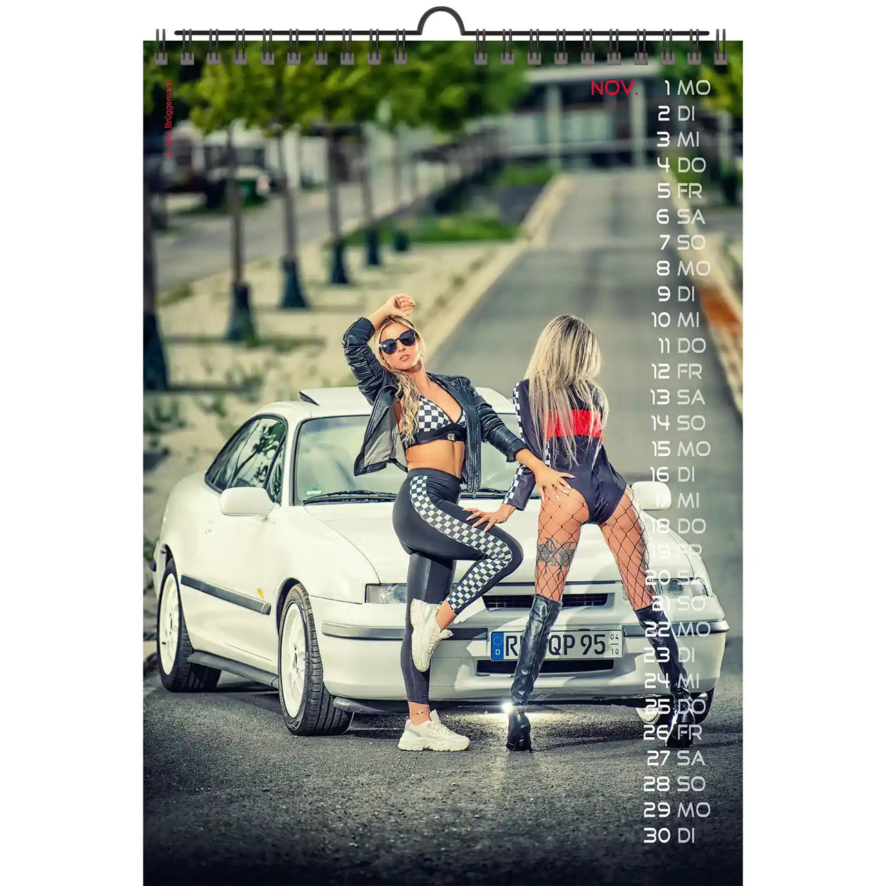 calendar with two woman in racing suits in front of a white car