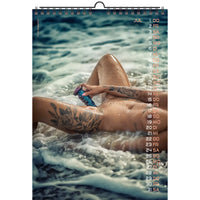 Calendar with a person sitting in water, holding a toy, with a beach scene.