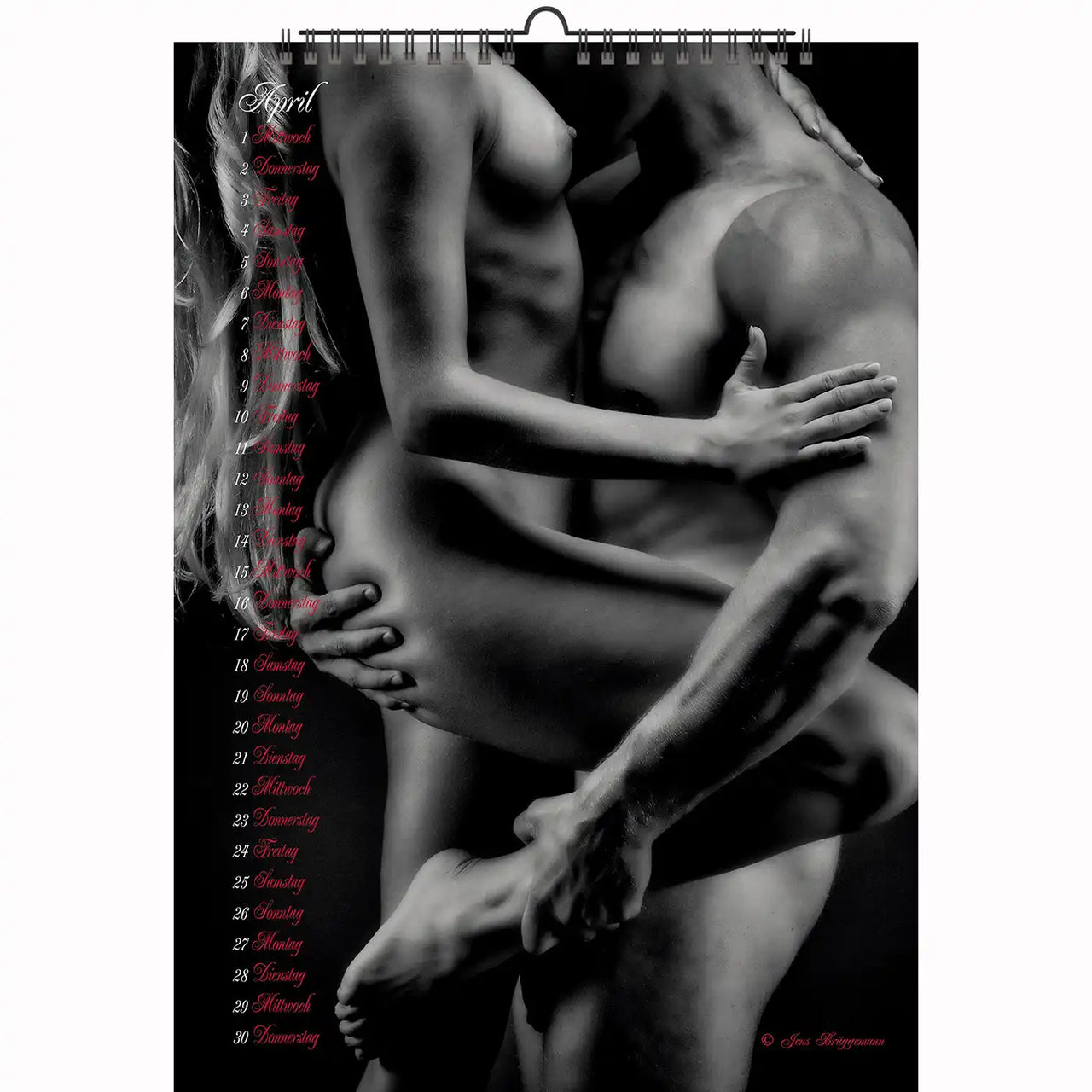 Passionate embrace of two women on a wooden floor in bondage-inspired lingerie, exuding intensity and erotic power