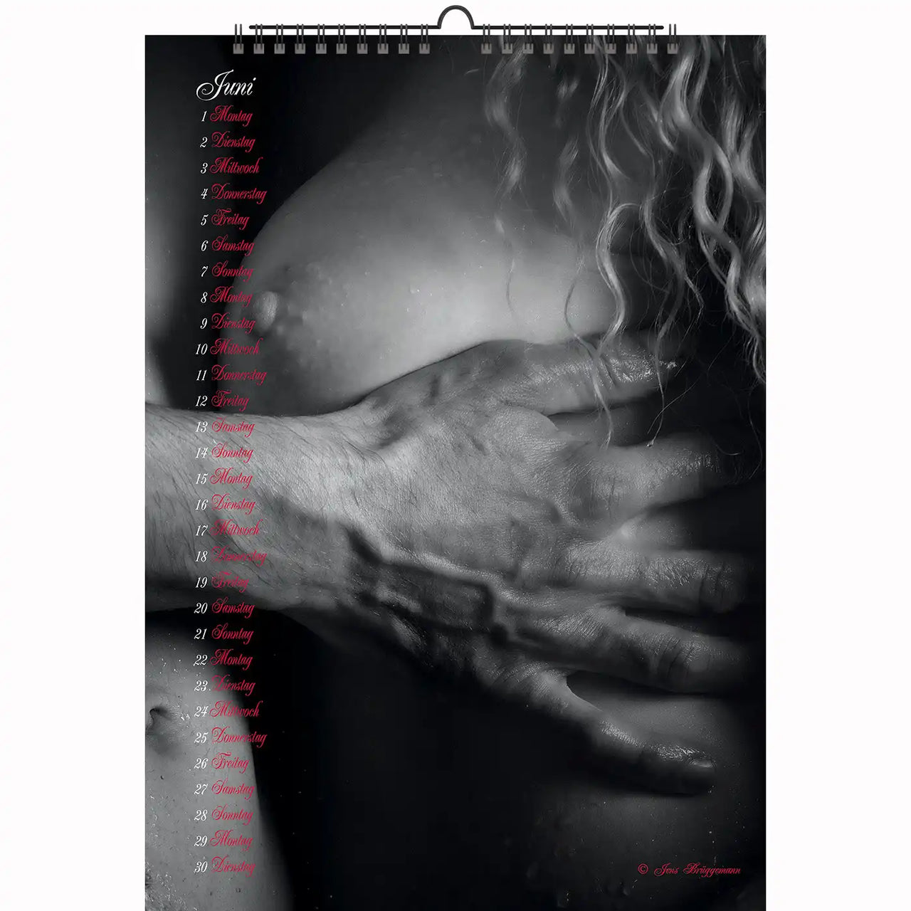 Intimate moment of oral pleasure with a woman in harness lingerie and a tattooed arm, showcasing bold erotic expression