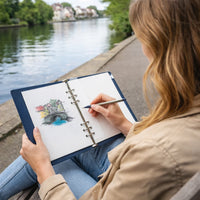 Person drawing by a lake