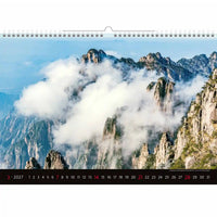 Kalender met een schilderachtig berglandschap met wolken en een helderblauwe lucht.
