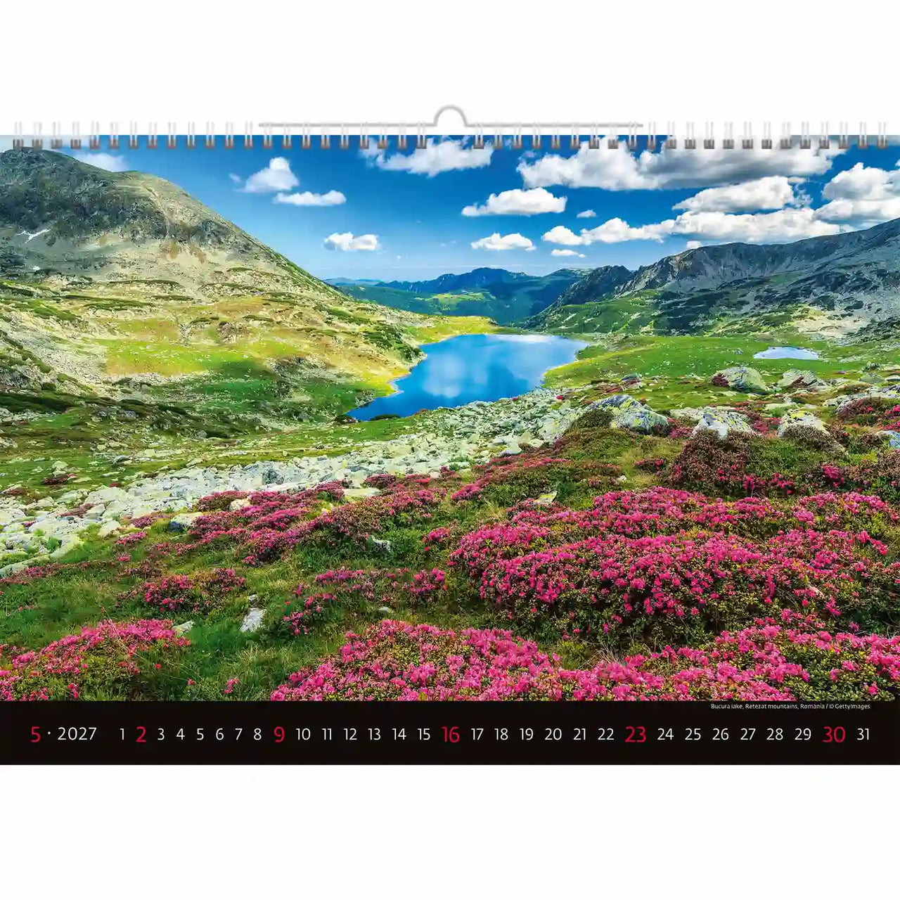 Kalender met een schilderachtig uitzicht op de bergen en een meer met roze bloemen.