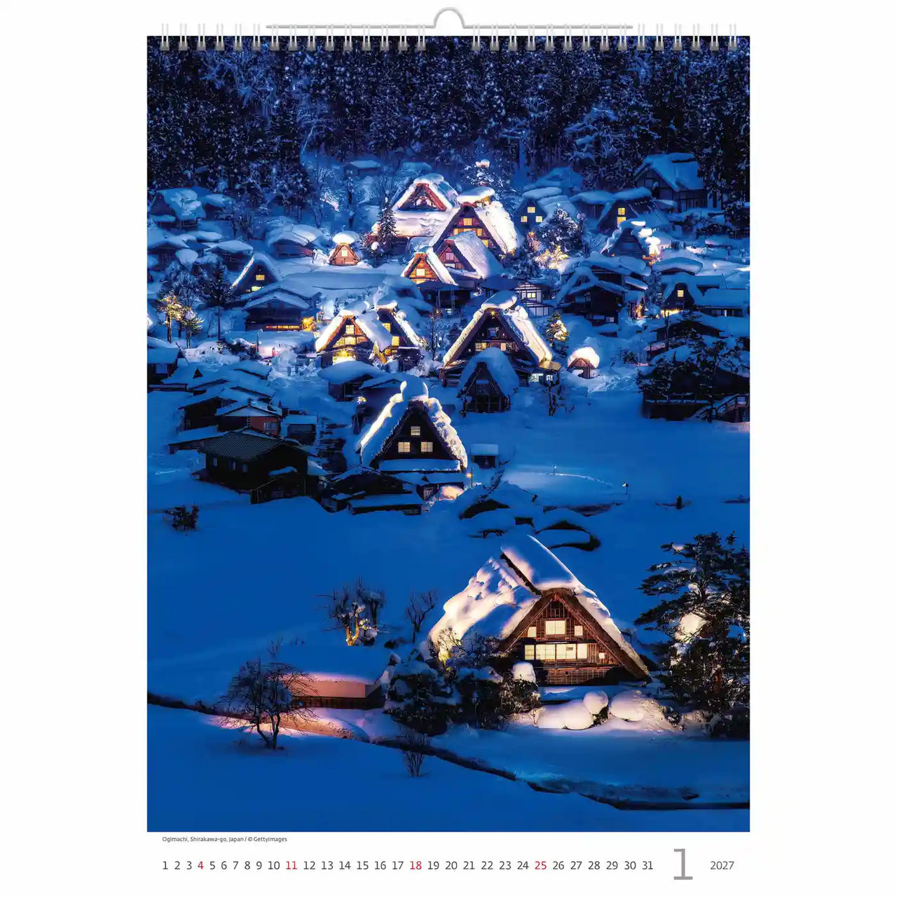 Met sneeuw bedekt dorp bij nacht met verlichte huizen, waarschijnlijk afkomstig van een kalender.