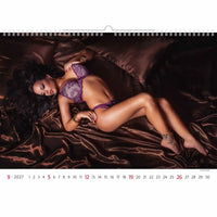 Calendar page showing a woman in purple lingerie lying on a brown satin blanket.