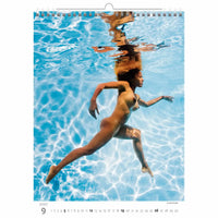 Calendar page showing a woman swimming underwater with a clear blue water background.