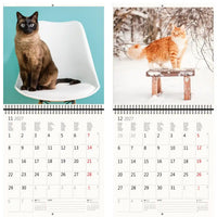 Kalender met twee kattenafbeeldingen en een besneeuwd landschap
