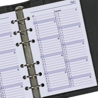 Close-up of a planner with a monthly calendar on a black background