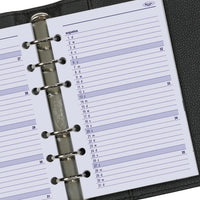 Close-up of a planner with a metal ring binding on a black background