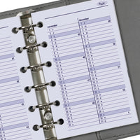 Close-up van een planner met een ringbandsysteem op een grijze achtergrond