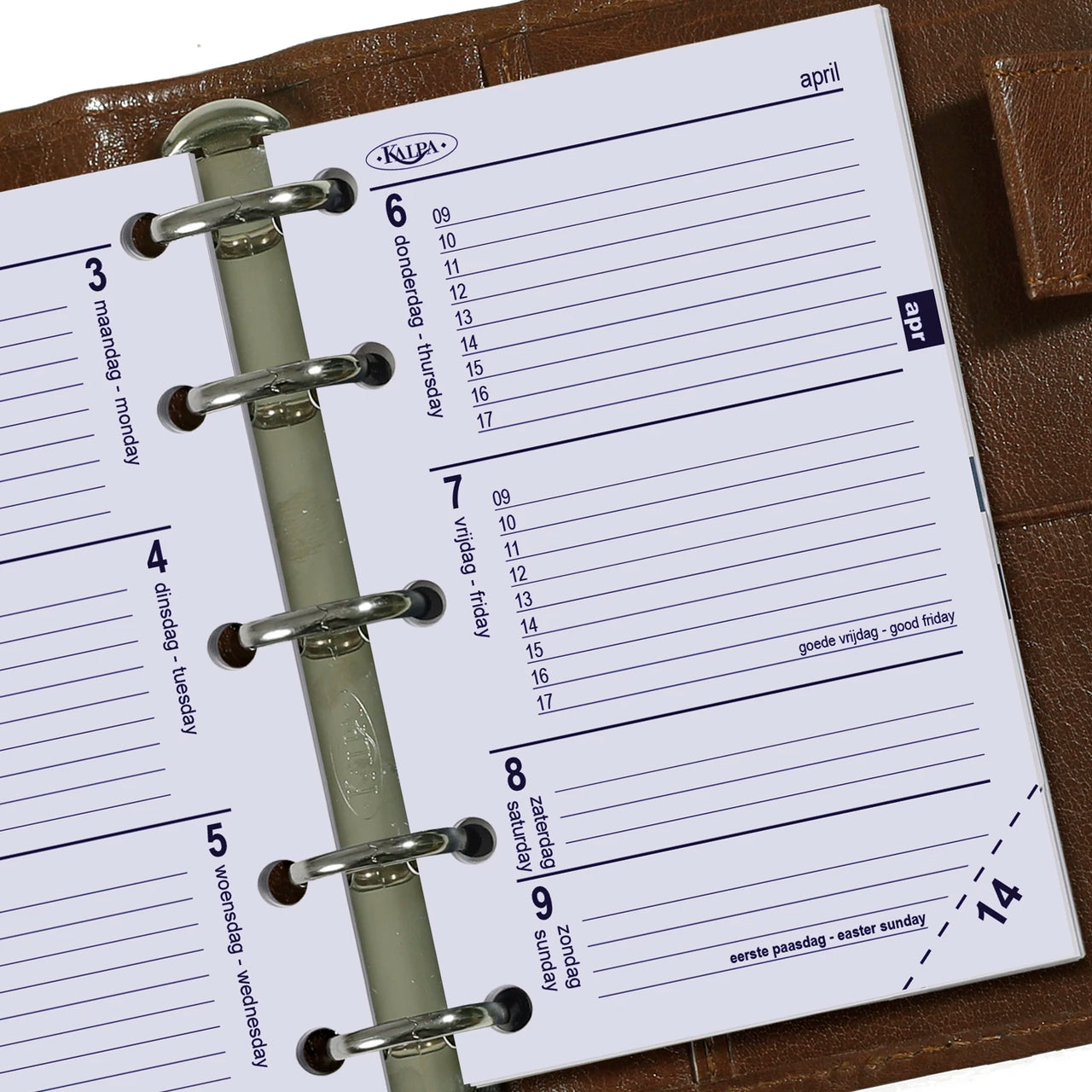 Close-up of a planner with a KLM logo on a wooden surface