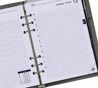 Open planner with daily layout and calendar on a white background