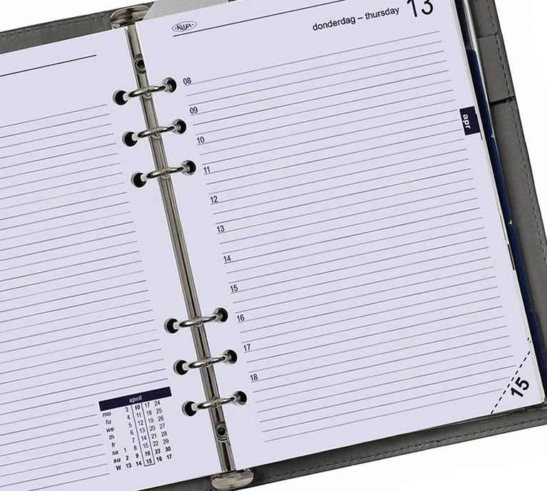Open planner with daily layout and calendar on a white background