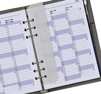 Close-up of a planner with monthly calendar pages.