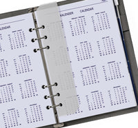 Calendar pages in a ring-bound planner with visible text and dates.