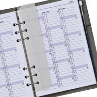 Close-up of a planner with a monthly calendar layout on a white background
