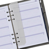 Open planner with lined pages and a pen holder on a white background