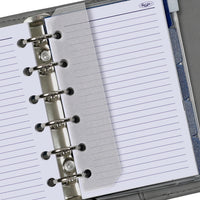 Close-up of a ring-bound notebook with lined pages