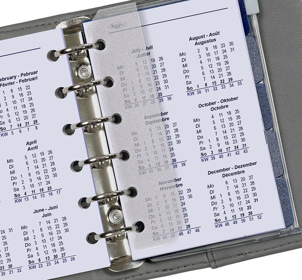 Close-up of a planner with a calendar page showing months.