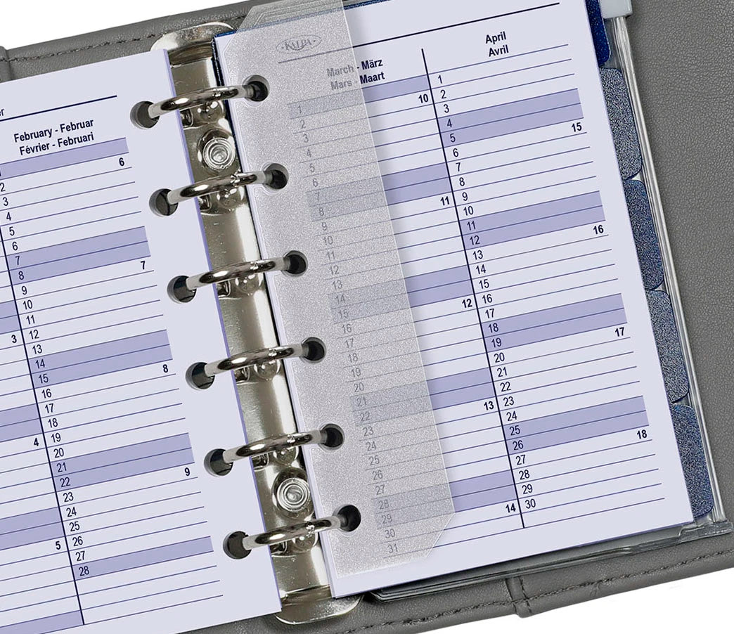 Close-up of a planner with a monthly layout, showing days of the week and dates.