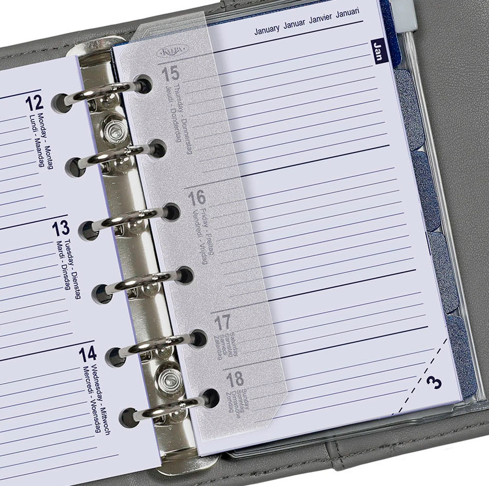 Close-up of a planner with a metal binding and clear cover