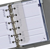 Close-up of a planner with a metal binding and clear cover