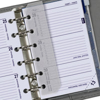 Close-up of a planner with a metallic ring binding and lined pages.